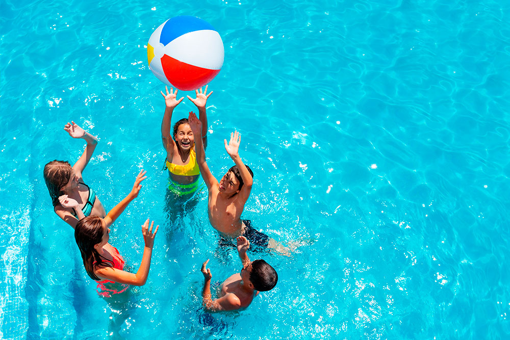 Guests In Water Playing With Beach Ball